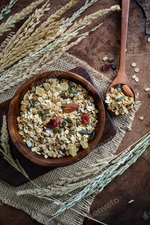 Preview: Oat and whole wheat grains flake in wooden bowl on wooden table