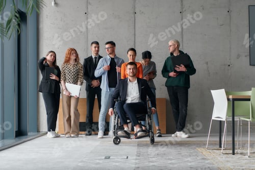 Preview: A diverse group of business professionals walking together through the office, symbolizing unity and