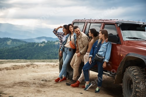 Preview: Joyful Group Of Friends Spending An Active Weekend In The Mountains While Standing Near Off Road