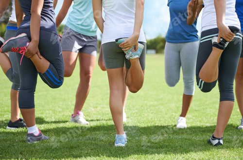 Preview: A group of teenage girls stretching. Warming up as a team.