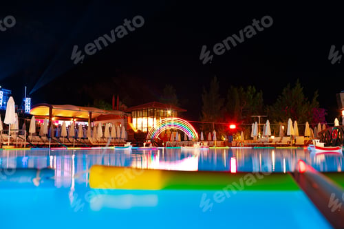 Preview: Swimming pool at a luxury resort at night time
