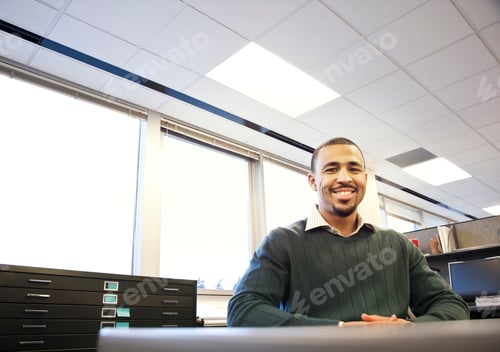 Preview: A portrait of a Black businessman in his corporate office.