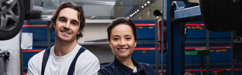 Preview: Young mechanics looking at camera in auto service, banner