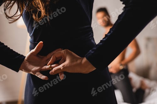 Preview: Selective focus of woman with hands behind back taking off wedding ring near shirtless man in