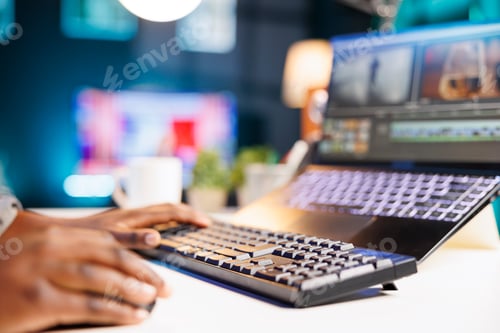 Preview: Black individual edits footage on laptop