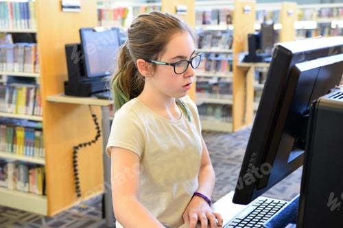 Preview: Girl using a computer at the public library