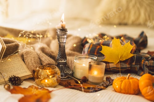 Preview: Sweaters and candles with autumn decor and book. Read, Rest. Still life details in home interior.