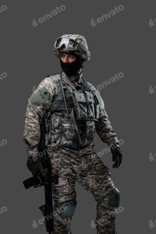 Preview: Special force soldier with rifle posing against gray background