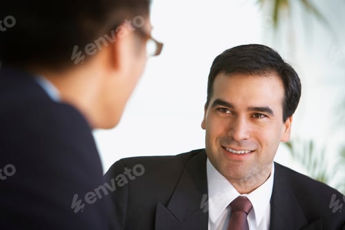 Preview: Business colleagues talk in a lobby