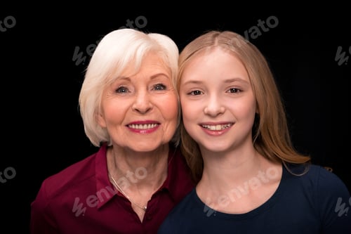 Preview: portrait of happy grandchild and grandmother looking at camera isolated on black