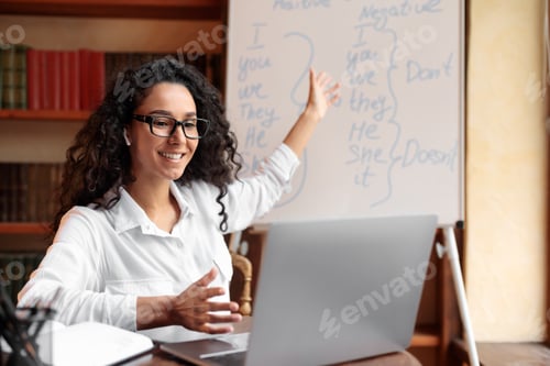 Preview: English teacher sitting at desk, explaining lesson to students