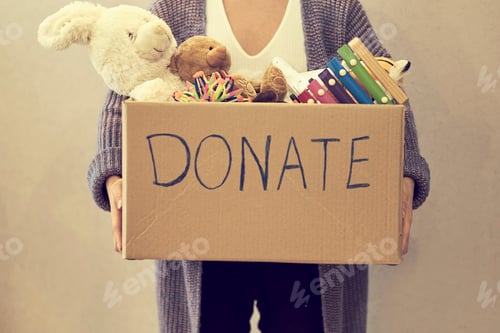 Preview: Donation box with children toys. woman collects toys for charity.