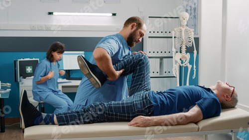 Preview: Medical assistant supporting old man in doing physical exercise