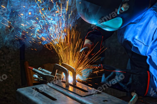 Preview: As a worker welds steel with gas argon, sparks are generated that smoke inside factory