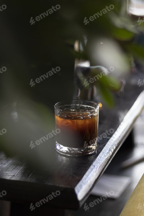 Preview: Vertical shot of iced coffee on a wooden table