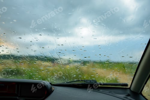 Preview: Raindrops on the windshield of the car.