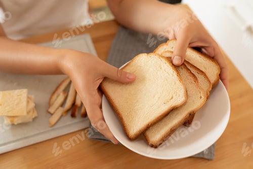 Preview: the woman put slices of bread on a plate