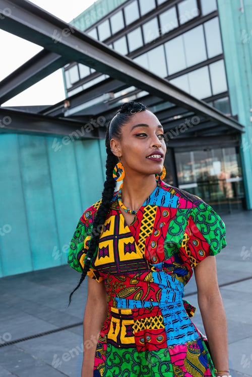 Preview: Ethnic woman standing near turquoise wall