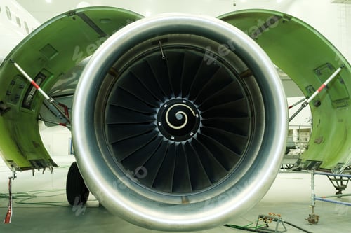 Preview: Large aircraft engine is showcased indoors, highlighting intricate details of its design