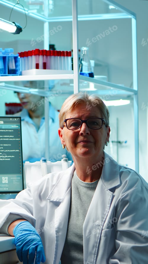 Preview: Portrait of senior scientist woman looking exhausted at camera