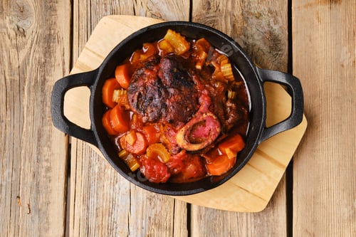 Preview: Overhead view of cast iron skillet with ossobuco