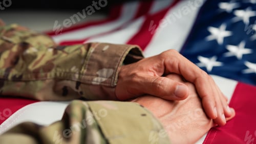 Preview: Military man in Uniform touching USA flag with his hand