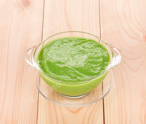 Preview: Broccoli cream soup on wood.