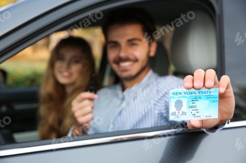 Preview: Young man holding driving license in car with passenger. Space for text