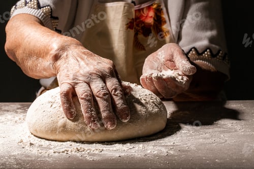 Preview: Preparing traditional homemade bread. Close up view of old woman, grandmother kneading dough