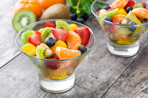 Preview: Fresh fruit salad with strawberries, blueberries, kiwi, mandarin and mango in glass bowls