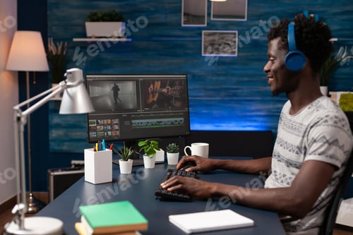 Preview: Filmmaker editor sitting at desk table in creativity studio