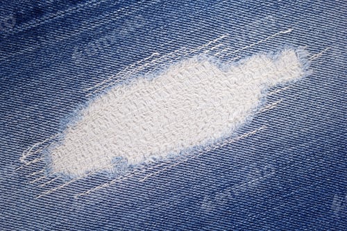 Preview: Blue jeans denim background texture. Torn jeans fabric material surface