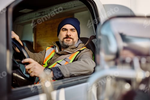 Preview: Truck driver using side mirror while driving in reverse.