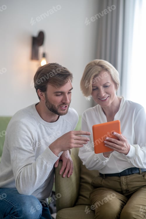 Preview: Woman and Man Looking at a Tablet Device