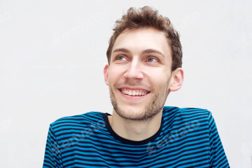 Preview: Close up happy young man by isolated white background looking up