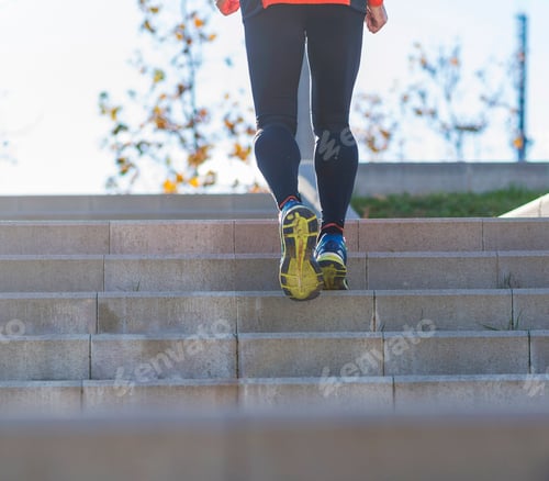 Preview: senior caucasian athlete man training running up and down the stairs outdoors in a park