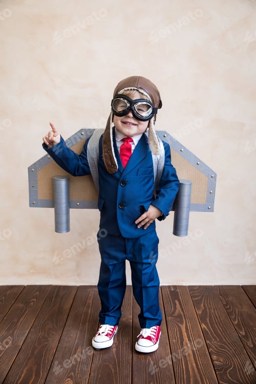 Preview: Portrait of young businessman with toy paper wings
