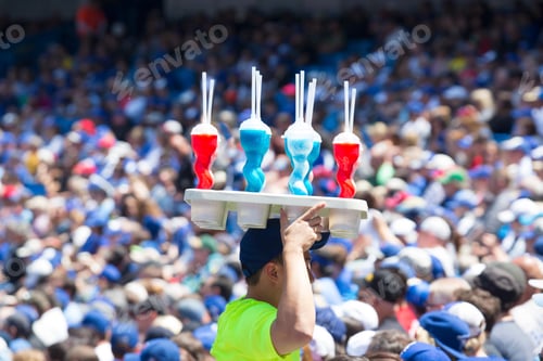 Preview: Man carrying tray with soft drink bottles on his head through a crowd