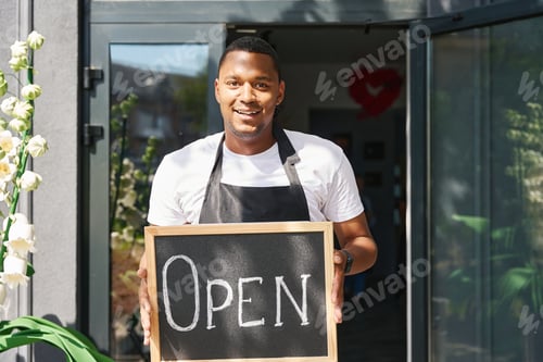 Preview: Guy holds the board open at the entrance to the store