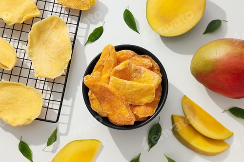 Preview: A bowl of dried mango chips with fresh sliced mango