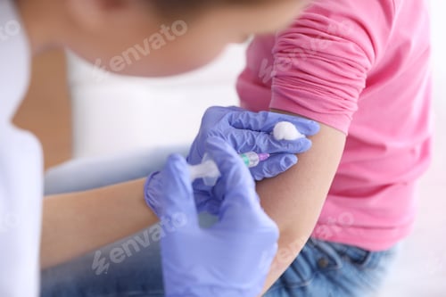 Preview: Little girl receiving chickenpox vaccination in clinic, closeup. Varicella virus prevention