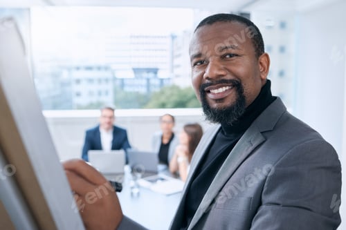 Preview: Portrait of a mature businessman using a whiteboard during a presentation in an office