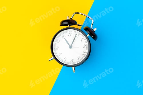 Preview: Black alarm clock on color block yellow and blue background