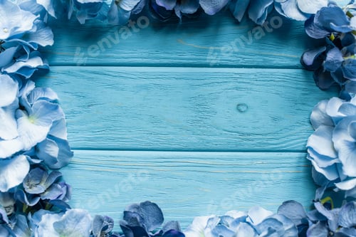Preview: top view of wooden blue background with floral frame