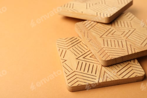 Preview: Stylish wooden cup coasters on orange background, space for text