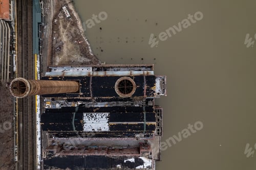 Preview: Aerial top view of two rustic industrial chimneys on the Hudson river in New York