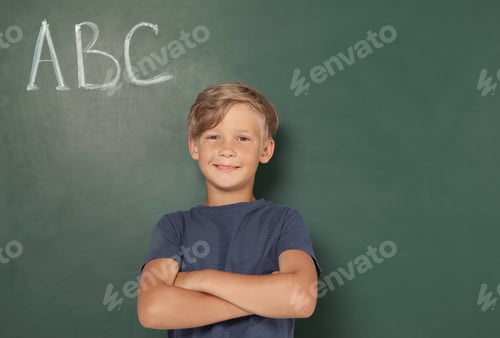 Preview: Little school child near chalkboard with letters ABC