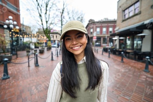 Preview: Happy pretty cute Asian teen girl standing outdoors looking at camera. Portrait.