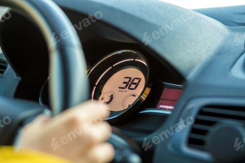 Preview: Modern car interior with driver hand on steering wheel. Safe driving concept.