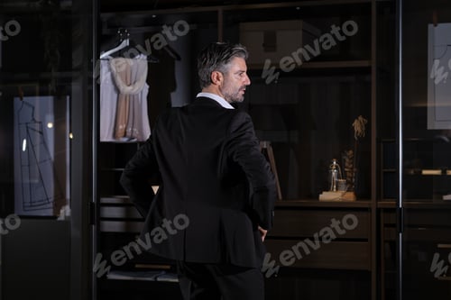 Preview: Adult male in elegant suit near wardrobe